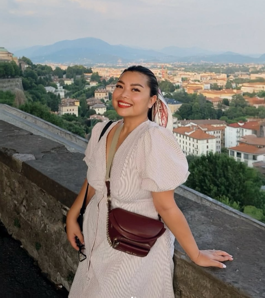Jhayde smiling on a wall above the rooftops of Bergamo, Italy