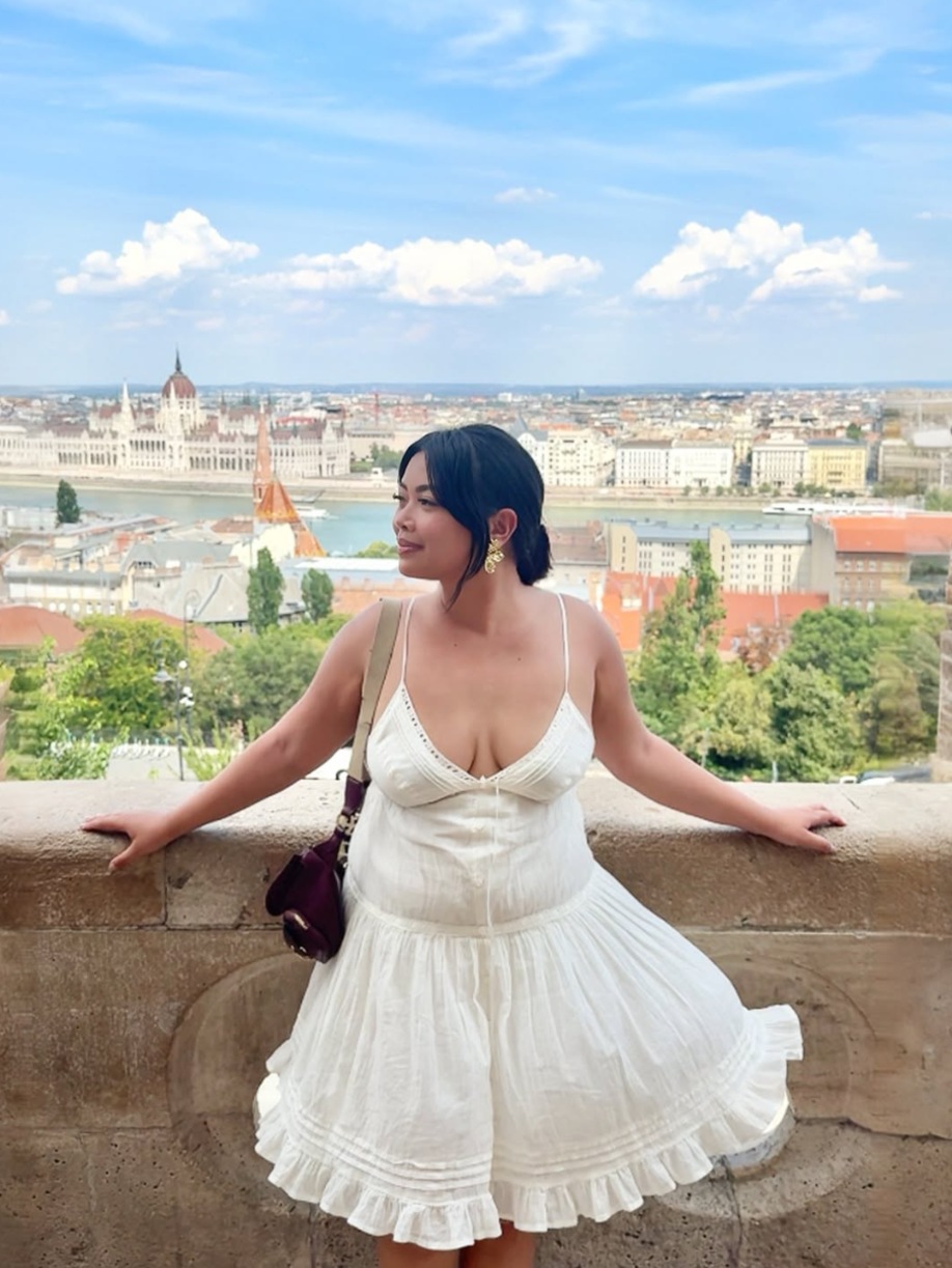Jhayde at Fisherman's Bastion with the Hungarian Parliament behind her in Budapest