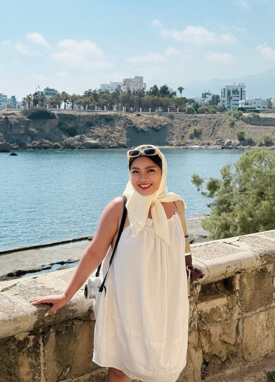 Jhayde with a camera on the harbour wall above the sea in Kyrenia, Cyprus